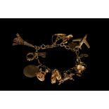 A 9CT GOLD CHARM BRACELET, with charms,