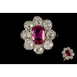 A RUBY AND DIAMOND CLUSTER RING, one cushion cut ruby of 1.
