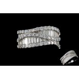 A DIAMOND WAVE STYLE BAND RING, mounted in 18ct white gold,