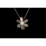 A DIAMOND AND MOTHER OF PEARL FLOWER PENDANT, by Van Cleef and Arprell, with diamonds of approx. 0.