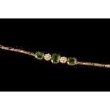 A PERIDOT AND CULTURED PEARL BRACELET, with step cut peridots of approx. 19.