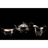 A LATE VICTORIAN THREE PIECE SILVER TEASET, with gadrooned decoration,