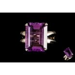 AN AMETHYST DRESS RING,