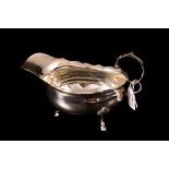 AN EDWARDIAN SILVER HELMET SHAPED SAUCE BOAT,