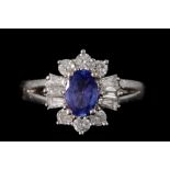 A DIAMOND AND TANZANITE CLUSTER RING, the oval tanzanite of approx. 1.