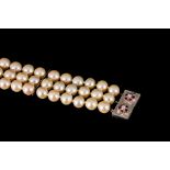 A TRIPLE STRANDED PEARL BRACELET,