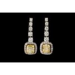 A PAIR OF YELLOW AND WHITE DIAMOND EARRINGS, with GIA cert stating the yellow diamonds to be 1.