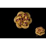 A RUBY AND GOLD FLORAL DRESS RING,