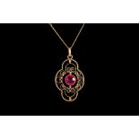 AN ANTIQUE TOURMALINE SET PENDANT, scrolled decoration, mounted in yellow gold,
