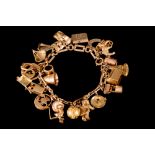 A 9CT GOLD CHARM BRACELET