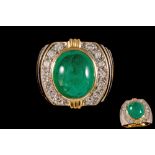 AN EMERALD AND DIAMOND RING, with cabochon emerald of approx.