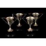 FOUR PLAIN SILVER TROPHY CUPS, on plinths, Birmingham 1950,