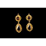 A PAIR OF GARNET DROP EARRINGS, in yellow gold filigree settings with shepherds hook fittings.