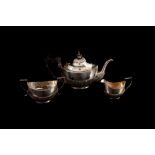 AN EDWARDIAN SILVER THREE PIECE BACHELOR TEA SERVICE, with gadrooned decoration,