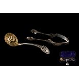 A VICTORIAN SILVER SIFTER SPOON AND TONGS Sheffield 1873.