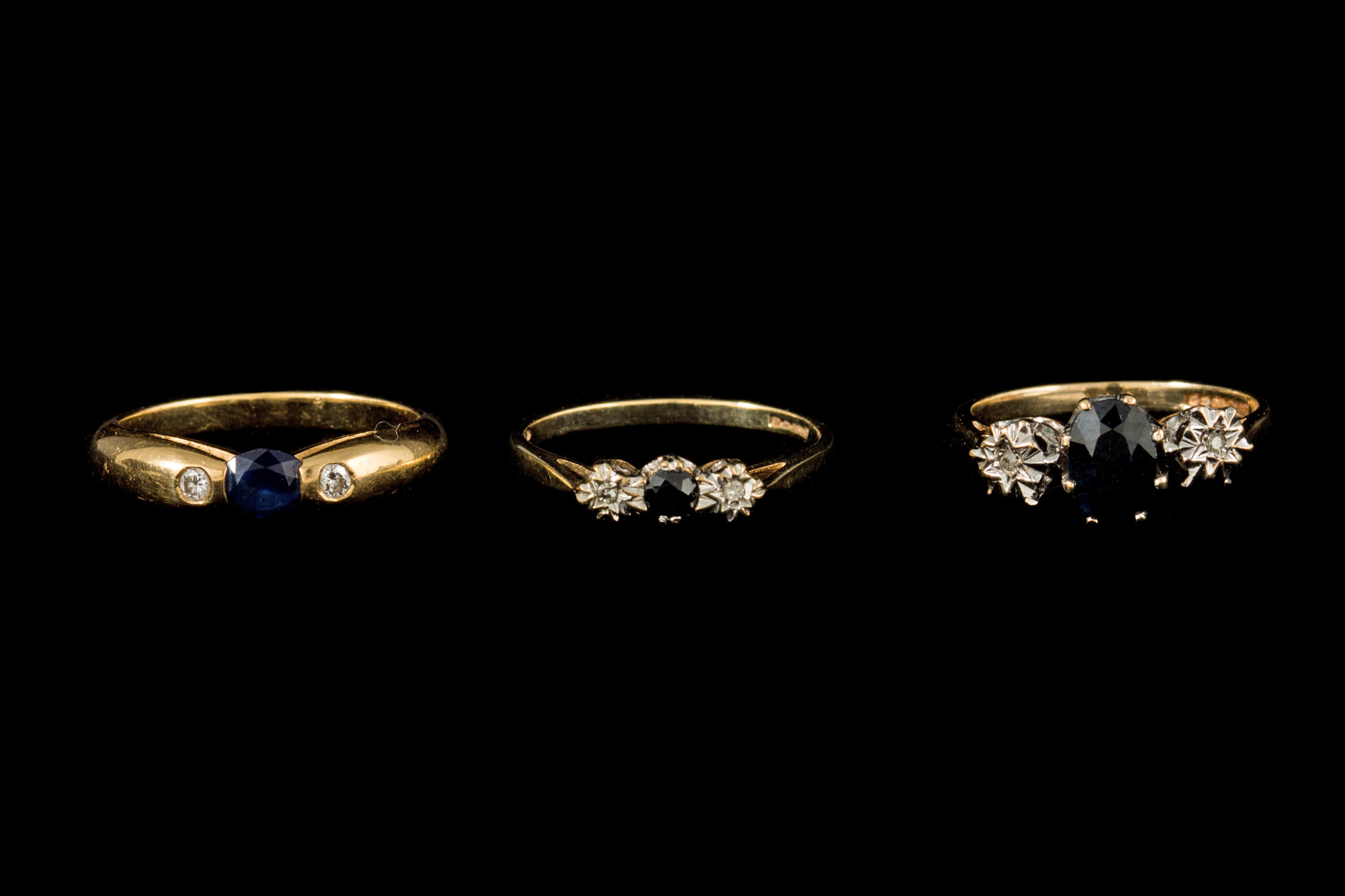 A SAPPHIRE AND DIAMOND THREE STONE RING, together with two others,