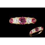A LATE VICTORIAN RUBY AND DIAMOND CARVED DRESS RING, set with rubies of approx. 0.