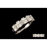 A TWO ROWED DIAMOND HALF ETERNITY RING, set with brilliant and baguette cut diamonds,
