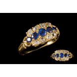 AN EDWARDIAN SAPPHIRE AND DIAMOND DRESS RING, with round cut sapphires of approx. 0.
