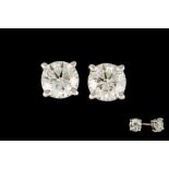 A PAIR OF DIAMOND SOLITAIRE STUD EARRINGS, with two round brilliant cut diamonds of approx. 3.