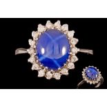 A STAR SAPPHIRE CLUSTER RING,