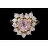 A PINK GEMSTONE AND DIAMOND CLUSTER RING, the heart shaped gem to a diamond surround,