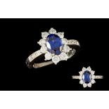 A SAPPHIRE AND DIAMOND CLUSTER RING, signed Tiffany & Co, one oval cut sapphire of approx 1.