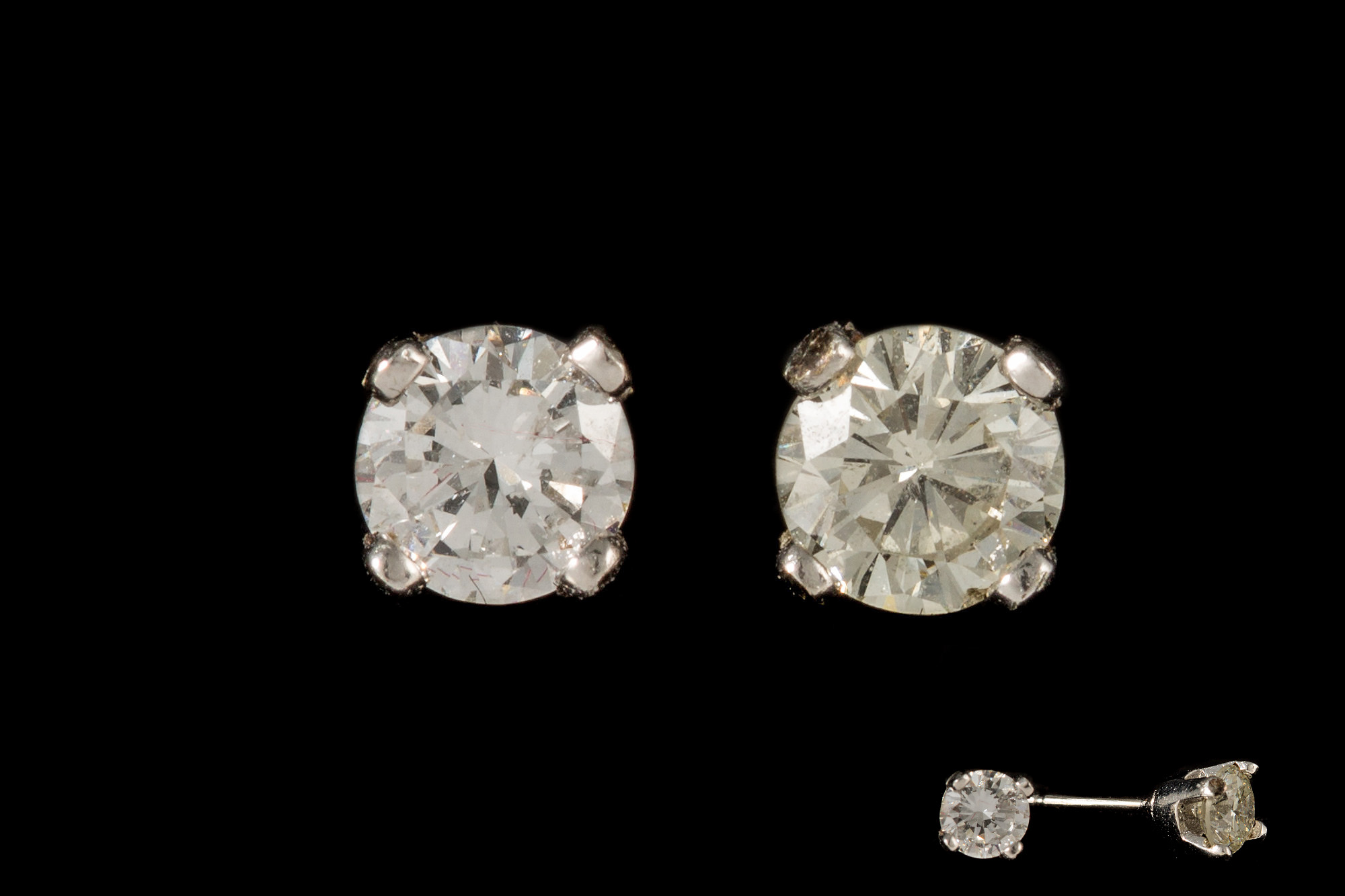A PAIR OF DIAMOND STUD EARRINGS, the brilliant cut diamonds mounted in white gold.