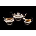 A GEORGE V SILVER THREE PIECE TEA SERVICE, with applied egg and dart border,