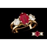 A RUBY AND DIAMOND THREE STONE RING, set with an oval ruby to brilliant cut diamonds,