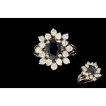 A DIAMOND AND SAPPHIRE CLUSTER, the oval sapphire to a brilliant cut diamond surround,