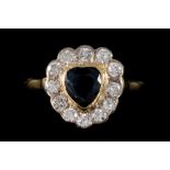 A SAPPHIRE AND DIAMOND CLUSTER RING, the heart shaped sapphire to a brilliant cut diamond surround,
