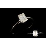 A DIAMOND SOLITAIRE RING, mounted in 14ct gold, set with an emerald cut diamond weighing 0.