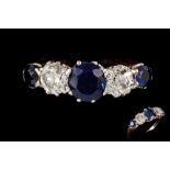 A SAPPHIRE AND DIAMOND FIVE STONE CARVED DRESS RING, three round cut sapphires of approximately 1.