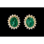 A PAIR OF EMERALD AND DIAMOND CLUSTER EARRINGS, of oval form, mounted in 18ct gold.