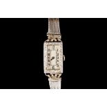 AN ART DECO LADIES COCKTAIL WRIST WATCH, diamond set bezel to a platinum case,