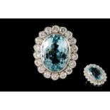 AN AQUAMARINE AND DIAMOND CLUSTER RING, the oval aqua to a brilliant cut diamond surround,