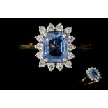 A DIAMOND AND TANZANITE CLUSTER RING, the rectangular tanzanite to a brilliant cut diamond surround,