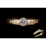 AN 18CT YELLOW GOLD DIAMOND SOLITAIRE, diamond set shoulders, centre stone est. 0.