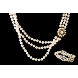 A THREE ROWED CULTURED PEARL NECKLACE, to a pearl cluster clasp,
