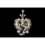 A LATE VICTORIAN DIAMOND BROOCH PENDANT, of floral openwork form with harp motif at centre,