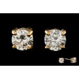 A PAIR OF DIAMOND STUD EARRINGS, the brilliant cut diamonds mounted in gold.