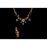 AN EDWARDIAN SEED PEARL CLUSTER NECKLACE, of floral design, mounted in yellow gold,