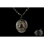 AN ANTIQUE CARVED MOURNING LOCKET,