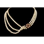 A TRIPLE STRAND PEARL NECKLACE,