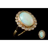 AN OPAL AND DIAMOND CLUSTER RING, the cabachon opal, to a brilliant cut diamond surround,
