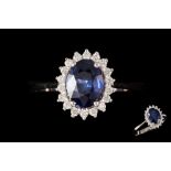 A SAPPHIRE AND DIAMOND OVAL CLUSTER RING, with sapphire of approx. 1.18ct, diamonds of approx. 0.