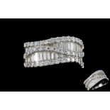 A DIAMOND WAVE STYLE BAND RING, mounted in 18ct white gold,