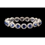 A SAPPHIRE AND DIAMOND OVAL CLUSTER LINK BRACELET, with sapphire of approx. 12.