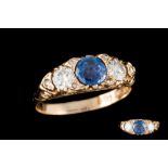A SAPPHIRE AND DIAMOND THREE STONE RING, a round cut sapphire of approx 0.